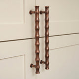 Grove Bamboo Cabinet Handle — room setting, Aged copper