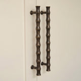 Grove Bamboo Cabinet Handle — room setting, Dark aged brass