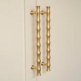 Grove Bamboo Cabinet Handle — room setting, Satin brass satin lacquered