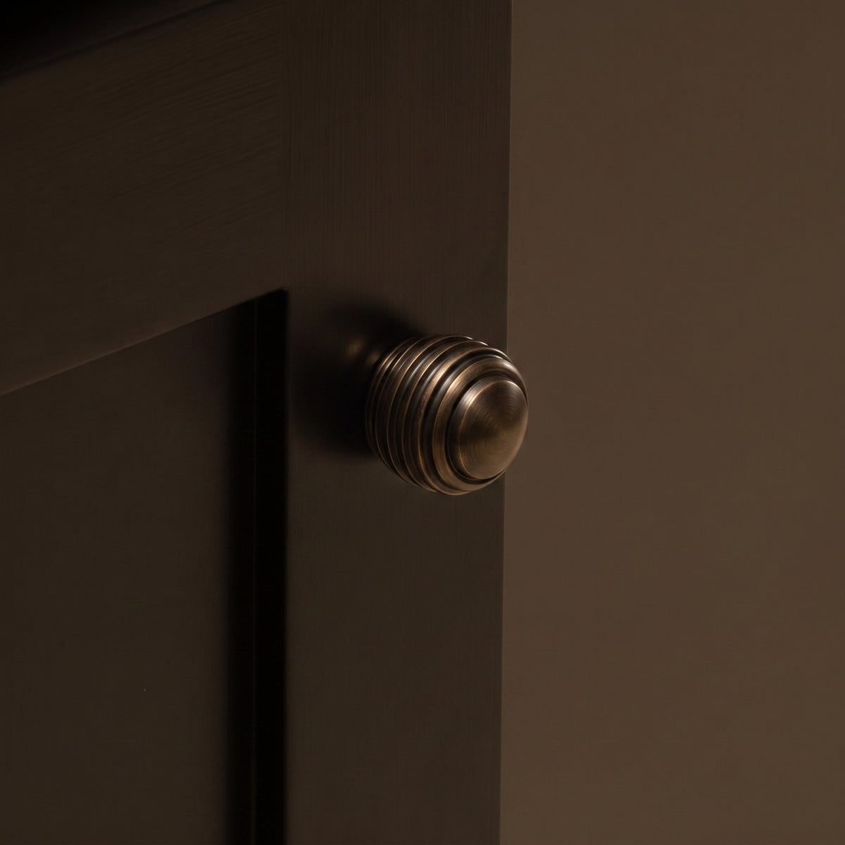 Nelson Cabinet Knob — room setting, Satin antique, unlacquered